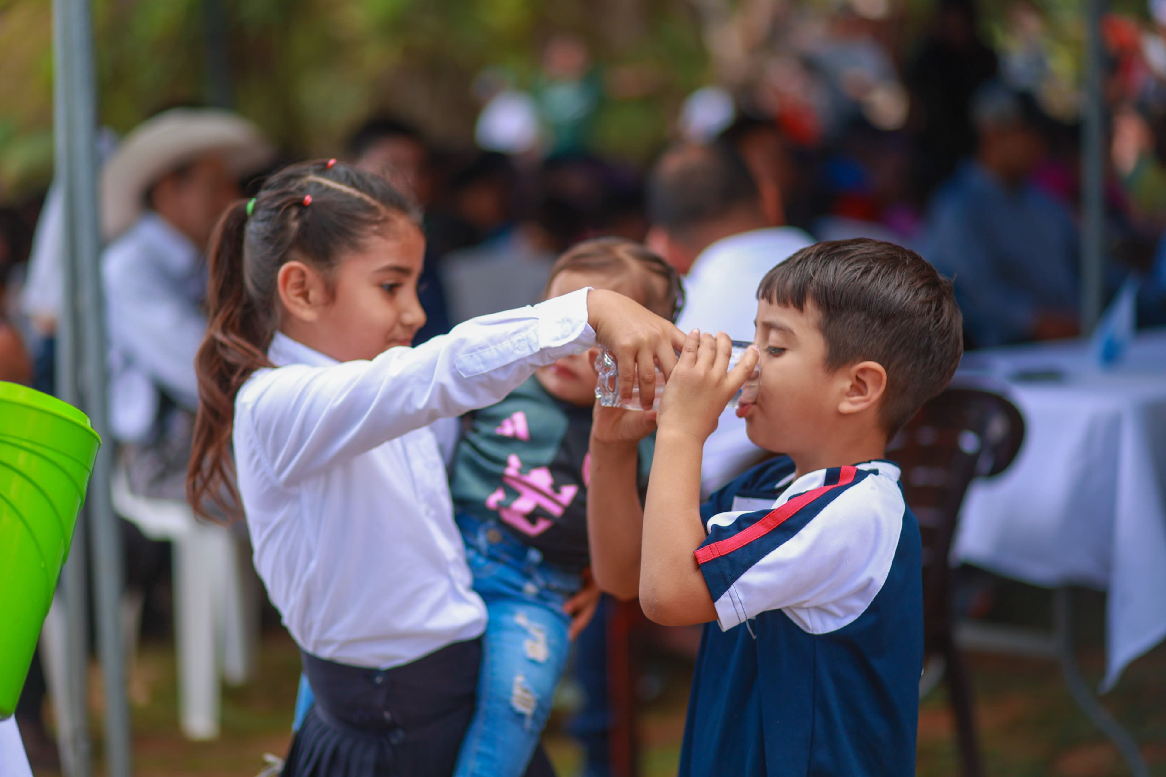 Kids drinking clean water from the new water foundation