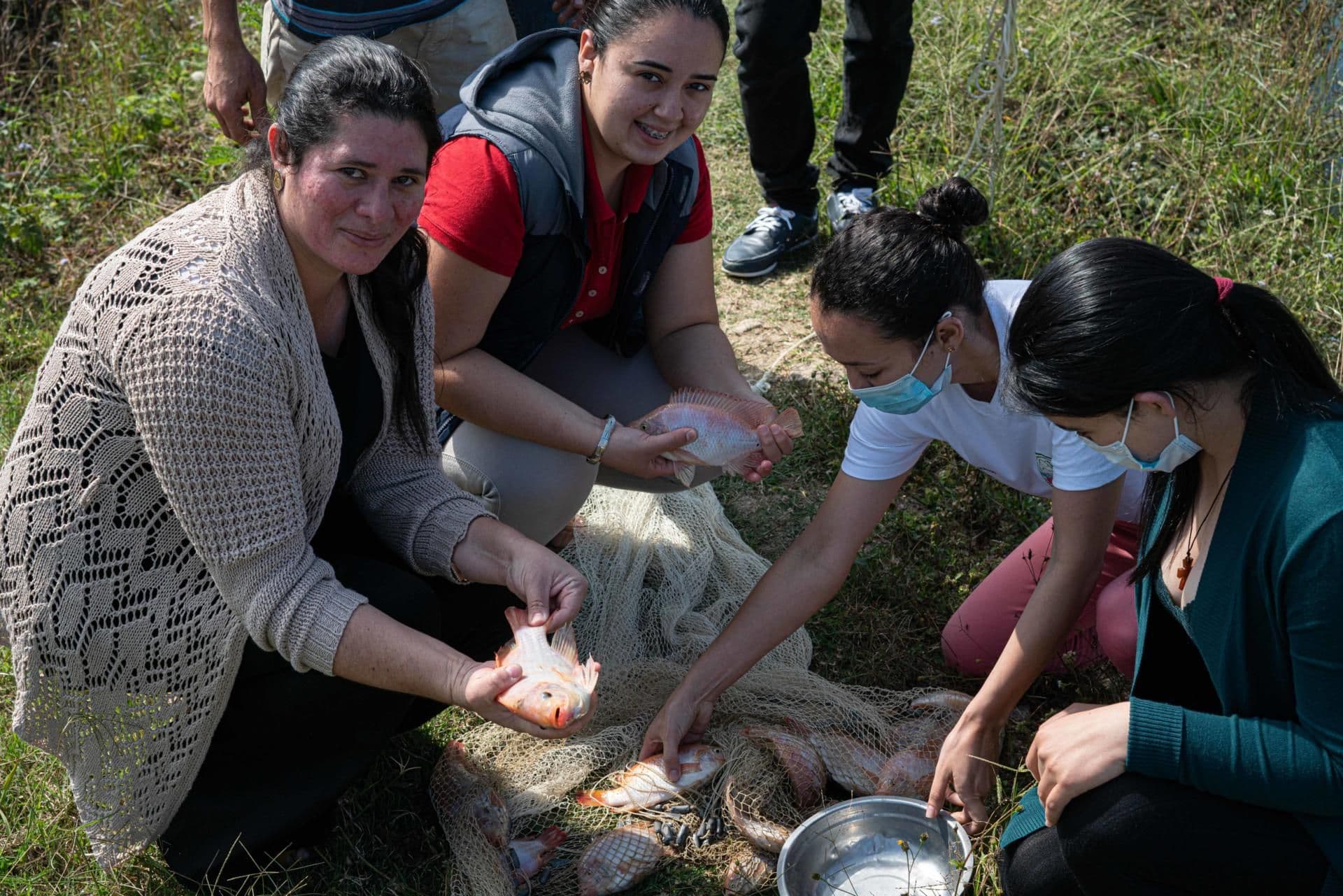 María teaching a group of women, part of the coffee cooperative, about fish farming María teaching a group of women, part of the coffee cooperative, about fish farming